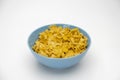 Pile of Golden cornflakes in the blue bowl ready for adding fresh milk for breakfast Royalty Free Stock Photo