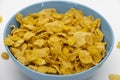 Pile of Golden cornflakes in the blue bowl ready for adding fresh milk for breakfast Royalty Free Stock Photo