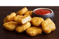 Pile of golden deep-fried battered chicken nuggets with empty ru