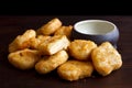 Pile of golden deep-fried battered chicken nuggets with empty ru Royalty Free Stock Photo