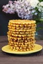Pile of golden homemade waffles on a saucer, photo of homemade baking