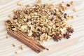 The Pile of granola cereal and cinnamon sticks on the wood backgroun Royalty Free Stock Photo