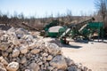Pile of gravel-rock.Blurred on background machinery of quarry. Royalty Free Stock Photo