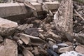 A pile of gray concrete fragments of construction debris close-up of the remains of a destroyed building. Background