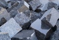 Pile of gray cube granite stones