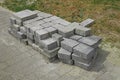 Pile of gray paving slabs stacked on the roadside