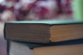 Pile of green books. The concept of reading. Close-up of toms on gradient background with reverberation. Selective focus