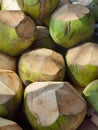 A pile of green, peeled coconuts on the top and bottom of the fruit Royalty Free Stock Photo