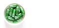 A pile of green pills on a white background Royalty Free Stock Photo