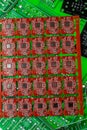 Pile of green, red and black printed circuit borads on top of each other