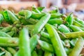 Pile of green snap peas pea pods being sold at a farmer`s market Royalty Free Stock Photo