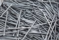 Pile of grey iron nails. Texture nails folded in one pile