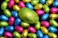 Pile or group of multi coloured & different sizes of colourful foil wrapped chocolate easter eggs in pink, blue, yellow and lime. Royalty Free Stock Photo