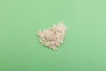 Pile of Guar gum powder on green surface, top view. Food additive E412. Guar gum or guaran powder widely used in food industry and Royalty Free Stock Photo