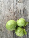 Pile of guava fruits from farm on wooden table, Assortment of exotic fresh fruits.