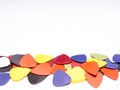 A pile of guitar picks isolated in white background with space for text Royalty Free Stock Photo