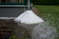 Pile of hail balls under rain gutter after heavy storm in a garden Royalty Free Stock Photo