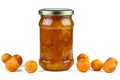 Pile of half-dried yellow cherry plums and glass jar with jam isolated on the white Royalty Free Stock Photo