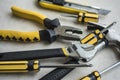 A pile of hardware tools on a solid background