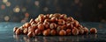 Pile of hazelnuts on a dark background with bokeh lights, close-up shot. Nutritious snack concept Royalty Free Stock Photo