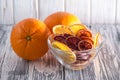 A pile of healthy colorful fruit chips on a white background in a transparent plate. Side view Royalty Free Stock Photo