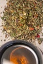 Pile of healthy herbs near a cup of herb tea isolated. Concept healthy diet, supplements, and food Royalty Free Stock Photo