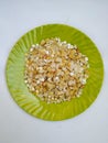 Pile of a Pongal Traditional Raw Mixtures of Ellu Bella in a Green Plate on white Background