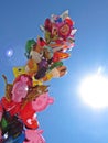 Pile of Helium Filled Flying Balloons for Children with the Sky and Sun in Background, May 2018, Warsaw Poland