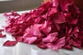 a pile of hibiscus petals on a marble countertop