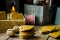 Pile of home baked Christmas gingerbread cookies in wood box, burning candle, red and white ribbon, pine cones and colorful bauble Royalty Free Stock Photo