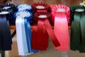 Pile of horse riding ribbons and trophy awards. Group of beautiful colorful trophies Royalty Free Stock Photo