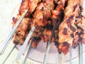 pile of hot cooked skewered shish kebabs