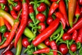 Pile of hot peppers border with space for text. Different green and red hot chili peppers frame isolated on white Royalty Free Stock Photo