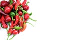 Pile of hot peppers border with space for text. Different green and red hot chili peppers frame isolated on white Royalty Free Stock Photo