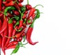 Pile of hot peppers border with space for text. Different green and red hot chili peppers frame isolated on white Royalty Free Stock Photo