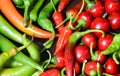 Pile of hot peppers border with space for text. Different green and red hot chili peppers frame isolated on white Royalty Free Stock Photo