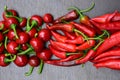 Pile of hot peppers border with space for text. Different red hot chili peppers. Long, cherry and small red peppers Royalty Free Stock Photo