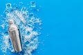 Pile of ice cubes and shaker on blue bar desk background top view space for text Royalty Free Stock Photo