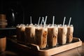 pile of iced coffee lattes, stacked in pyramid formation on wooden tray