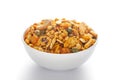 Pile of Indian spicy snacks Namkeen - `All in one` in a white bowl, made with fried peanut, corn flakes, sweet pea, pulses, cash Royalty Free Stock Photo