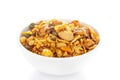 Pile of Indian spicy snacks Namkeen - `All in one` in a white bowl, made with fried peanut, corn flakes, sweet pea, pulses, cash Royalty Free Stock Photo