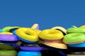 Pile of inflatable ring for swimming pool isolated on blue background Royalty Free Stock Photo