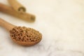 Pile of instant coffee grains over marbble surface. Caffiene drink. Copy space, toned. Royalty Free Stock Photo