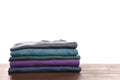 Pile of ironed clothes on table against white background Royalty Free Stock Photo