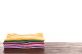 Pile of ironed clothes on table against white background Royalty Free Stock Photo