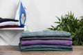 Pile of ironed clothes on table in room Royalty Free Stock Photo