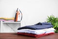 Pile of ironed clothes on table in room Royalty Free Stock Photo