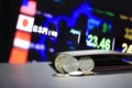 Pile of Japanese Yen coins JPY on black floor with black wallet and digital board of currency exchange money background. Royalty Free Stock Photo