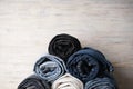 Pile of jeans on light wooden background, close-up Royalty Free Stock Photo
