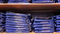 Pile of jeans on the shelf in the store. Close-up Royalty Free Stock Photo